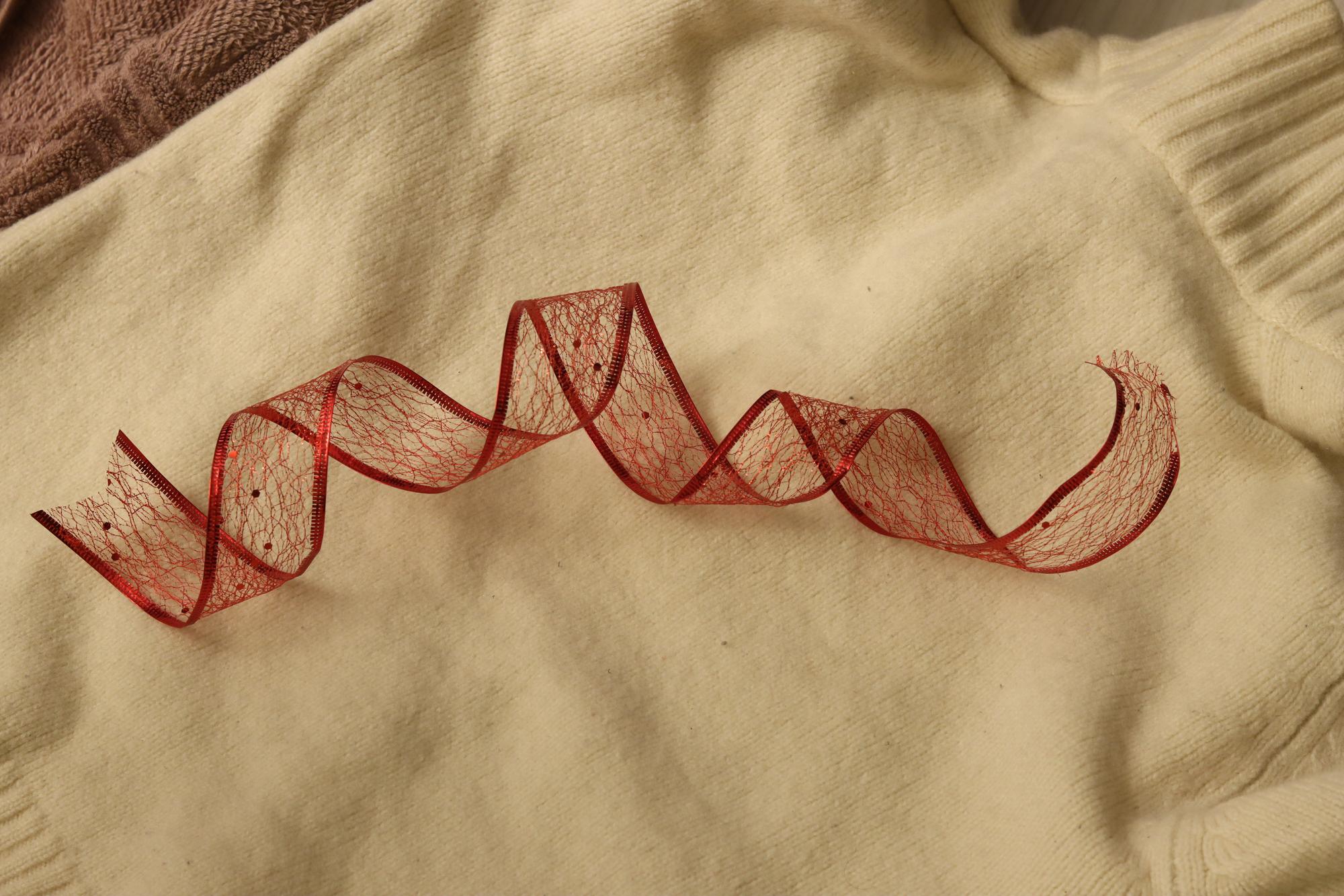 Close-up embroidered ribbon on natural linen
